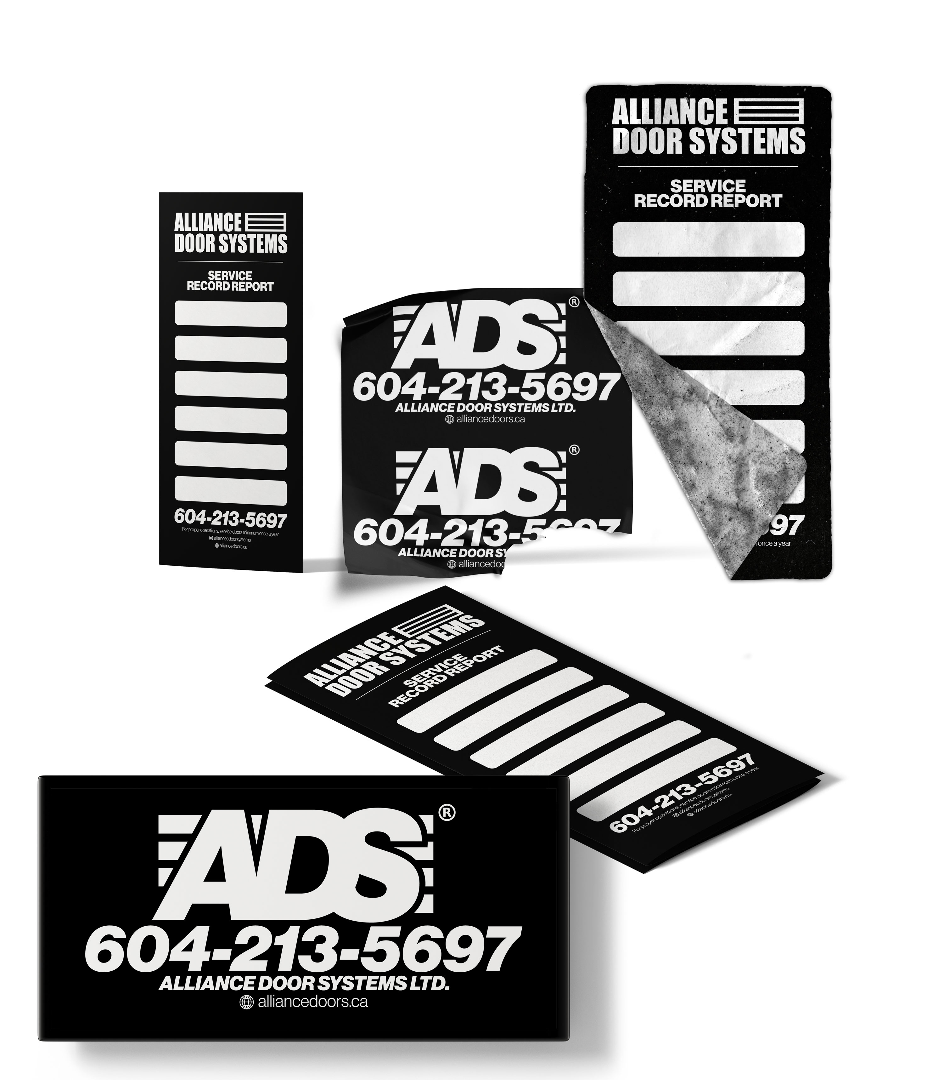 ADS service record stickers and labels in black and white, arranged as a flat lay